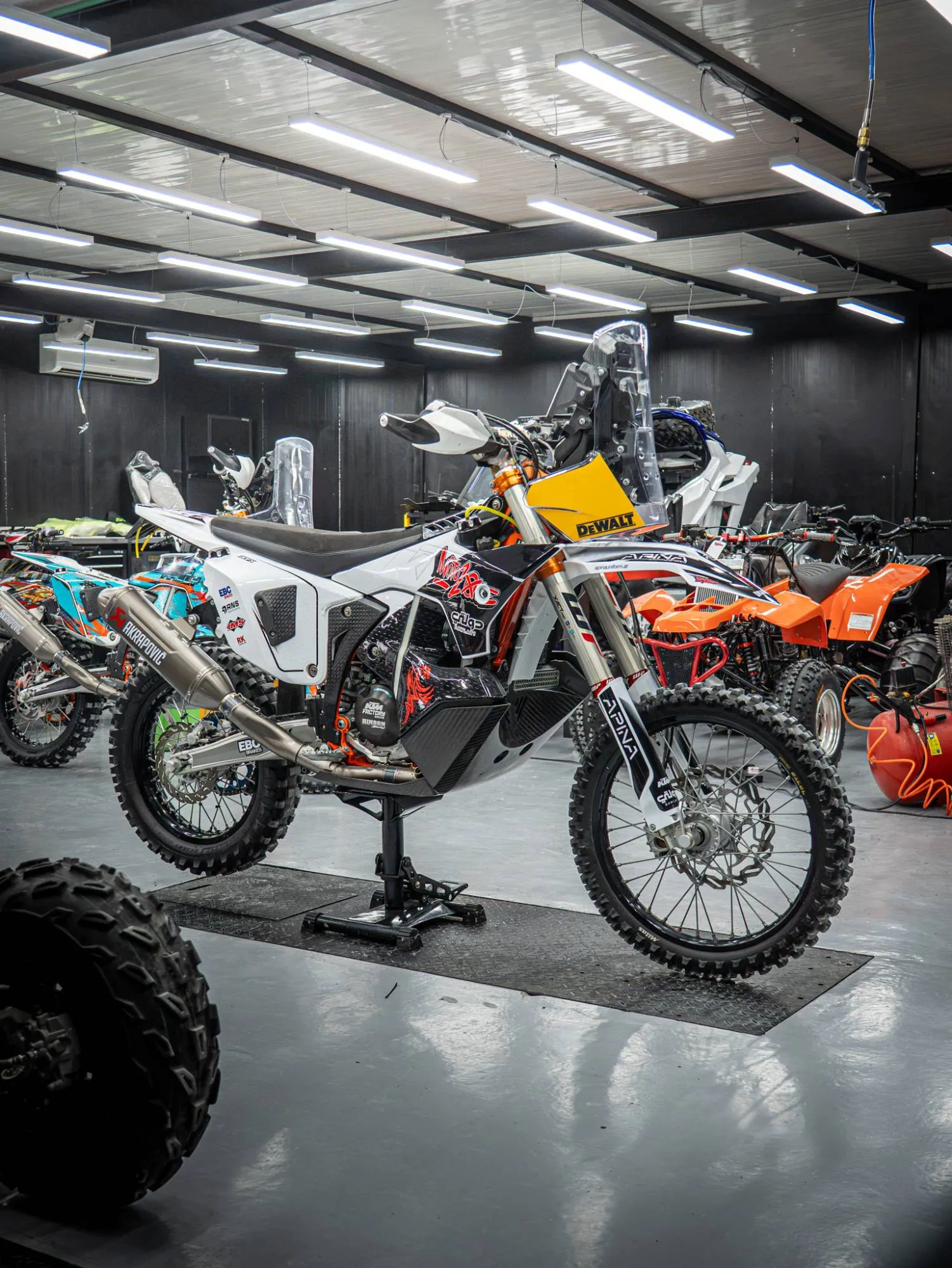 Alex&rsquo;s rally bike in the workshop, with its current partner logos