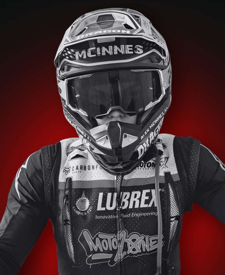 Alex McInnes in his McInnes helmet and goggles, wearing MotoZone and Lubrex race kit